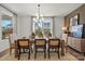 Bright dining room featuring modern light fixture, neutral color palette, and views of the outdoors at 5216 Mint Harbor Way # 0284, Charlotte, NC 28269