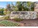 Beautiful stone entrance to Griffith Lakes with manicured landscaping and blooming flowers, creating a welcoming entry at 5216 Mint Harbor Way # 0284, Charlotte, NC 28269