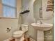 Small bathroom with pedestal sink, toilet and window at 12528 Generations St, Charlotte, NC 28278