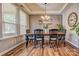 Dining area with hardwood floors, large windows, and a chandelier at 12528 Generations St, Charlotte, NC 28278