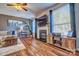 Living room with fireplace, hardwood floors, and large TV at 12528 Generations St, Charlotte, NC 28278