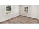 Bright bedroom with two windows, neutral walls, and light brown wood-look floors at 16 Hill St, York, SC 29745