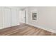 Simple bedroom with white closet doors, neutral walls, and wood-look floors at 16 Hill St, York, SC 29745