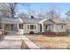 Charming ranch home with gray siding, covered carport, and rocking chairs on the porch at 16 Hill St, York, SC 29745