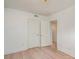 Simple bedroom with light wood floors and double doors to closet at 2423 Vail Ave # A12, Charlotte, NC 28207