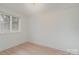 Simple bedroom with wood floors and window at 2423 Vail Ave # A12, Charlotte, NC 28207