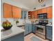 Modern kitchen with light wood cabinets and blue base cabinets at 2423 Vail Ave # A12, Charlotte, NC 28207