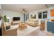 Living room with beige sofas, a TV, and a kitchen bar at 2423 Vail Ave # A12, Charlotte, NC 28207