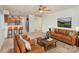 Living room with light brown sofas, coffee table, and kitchen area at 2423 Vail Ave # A12, Charlotte, NC 28207