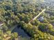 Aerial view of the neighborhood with lush trees and a glimpse of a pond at 8503 Foxbridge Dr # 16, Matthews, NC 28104