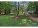 Spacious backyard with mature trees and lush green grass at 8503 Foxbridge Dr # 16, Matthews, NC 28104