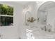 Bright bathroom featuring a marble countertop, dual sinks, and a window with wooded views at 8503 Foxbridge Dr # 16, Matthews, NC 28104