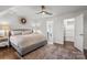 Comfortable bedroom showcasing a queen bed, ceiling fan, and hardwood floors at 8503 Foxbridge Dr # 16, Matthews, NC 28104