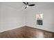 Bright bedroom with a ceiling fan, wood floors, and natural light through a window at 8503 Foxbridge Dr # 16, Matthews, NC 28104