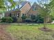 Attractive brick home with dormer windows, dark shutters and beautiful landscaping at 8503 Foxbridge Dr # 16, Matthews, NC 28104