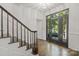 Bright foyer with hardwood floors, a staircase, modern lighting, and a glass door at 8503 Foxbridge Dr # 16, Matthews, NC 28104