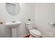 Simple half bathroom with pedestal sink and toilet at 9667 Laurie Nw Ave, Concord, NC 28027