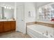 Bathroom with double vanity, soaking tub, and linen closet at 9667 Laurie Nw Ave, Concord, NC 28027