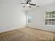 Bright bedroom with ceiling fan and neutral carpeting at 9667 Laurie Nw Ave, Concord, NC 28027