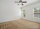 Well-lit bedroom with ceiling fan and neutral carpeting at 9667 Laurie Nw Ave, Concord, NC 28027