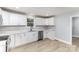 Modern kitchen featuring white cabinets, quartz countertops, and stainless steel appliances at 208 Valley St, Stanley, NC 28164