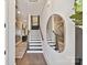 Inviting entryway with hardwood floors, statement mirror, and staircase with wooden handrail at 3020 Endhaven Terraces Ln # 10, Charlotte, NC 28277