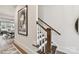 Hallway leading to a living room, featuring a staircase with wood and white accents at 3020 Endhaven Terraces Ln # 10, Charlotte, NC 28277