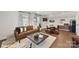 Open-concept living room with leather sofa, dining area, and modern accents at 3020 Endhaven Terraces Ln # 10, Charlotte, NC 28277