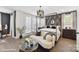 Stylish main bedroom features a four-poster bed, sitting area, and designer wallpaper for a luxurious feel at 3020 Endhaven Terraces Ln # 10, Charlotte, NC 28277