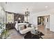 Spacious main bedroom with a four-poster bed, stylish seating, and access to a hallway at 3020 Endhaven Terraces Ln # 10, Charlotte, NC 28277