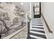 Elegant staircase featuring dark treads, white risers, and a decorative accent wall at 3020 Endhaven Terraces Ln # 10, Charlotte, NC 28277
