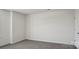 Empty bedroom featuring neutral paint, plush carpet, and a white door at 112 Rustling Waters Dr, Mooresville, NC 28117