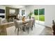 Dining area with glass table, neutral chairs, and sliding glass doors at 3925 Coleman Dr, Charlotte, NC 28215