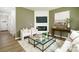 Living Room with corner fireplace, glass coffee table, and neutral color palette at 3925 Coleman Dr, Charlotte, NC 28215