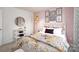 Bedroom with blush pink accent wall and patterned bedding at 5211 Reedy Ridge Rd, Charlotte, NC 28215