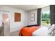 Bedroom with orange comforter and view of backyard at 5211 Reedy Ridge Rd, Charlotte, NC 28215