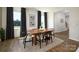 Modern dining room with hardwood floors, a wood table, and black chairs at 5211 Reedy Ridge Rd, Charlotte, NC 28215