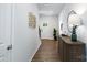 Bright entryway with hardwood floors, a console table, and a stylish wall decor at 5211 Reedy Ridge Rd, Charlotte, NC 28215