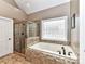 Bathroom with walk-in shower and soaking tub at 4730 Rollins Pointe Dr, Monroe, NC 28110