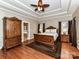 Main bedroom with hardwood floors and large wood armoire at 4730 Rollins Pointe Dr, Monroe, NC 28110