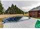 Inground pool with a wooden deck and covered with a winter tarp at 4730 Rollins Pointe Dr, Monroe, NC 28110