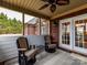 Relaxing screened porch with two armchairs and access to the backyard at 4730 Rollins Pointe Dr, Monroe, NC 28110