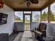 Covered porch with a view, comfortable seating, and a flat-screen TV at 4730 Rollins Pointe Dr, Monroe, NC 28110