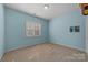 Light blue bedroom with window and neutral carpet at 263 Fernbrook Dr, Mooresville, NC 28117