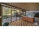 Screened porch with hot tub and wood tile floor at 263 Fernbrook Dr, Mooresville, NC 28117