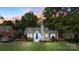 Gray house with blue door, illuminated at dusk, showcasing curb appeal at 3115 Westmoreland Ave, Charlotte, NC 28205