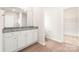 Bathroom featuring a granite countertop vanity with white cabinets and a shower behind a glass door at 3607 Clover Valley Dr, Gastonia, NC 28052