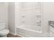 A bright bathroom with a white bathtub and toilet showcasing a clean and well-lit space at 3607 Clover Valley Dr, Gastonia, NC 28052