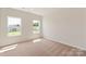 An airy bedroom with two windows that let in natural light, showcasing a calm and peaceful ambiance at 3607 Clover Valley Dr, Gastonia, NC 28052