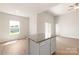 Open living space featuring a kitchen island, plenty of natural light, and wood-look flooring at 3607 Clover Valley Dr, Gastonia, NC 28052